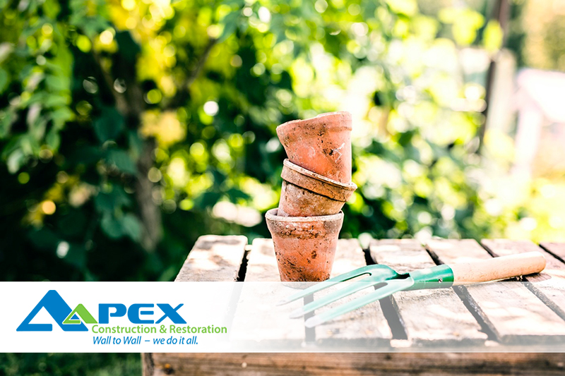 Landscaping tips to Prevent Basement Flooding - Pots and trowel pictured