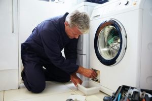 Man working on washing machine