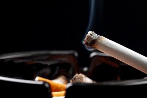 Cigarette in ashtray as a fire danger