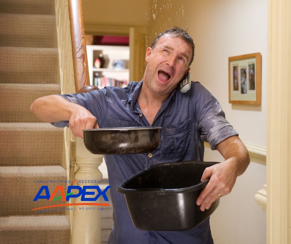 Man holding pans to stop leak