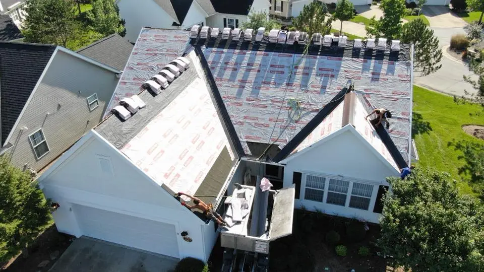 Arial view of a White House with roof construction under way