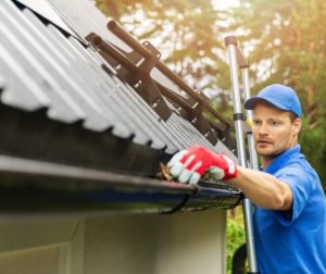 Man cleaning his gutters