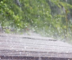 Heavy rain hitting a roof of a home.