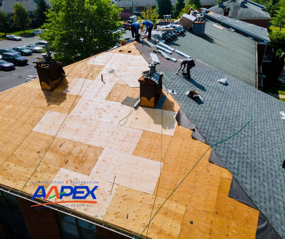A roofing team working on replacing the shingles on a house.