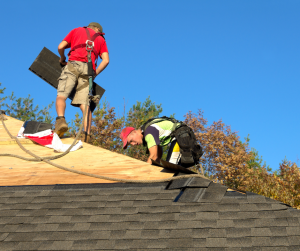 Roofers putting on new shingles in optimal weather.