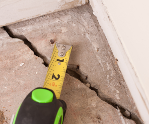 Measuring the width of a foundation crack.