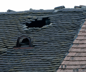 A roof of a house with severe damage.